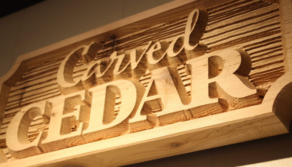 Carved Cedar - board with wood grain texture and raised letters