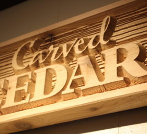 Carved Cedar - board with wood grain texture and raised letters