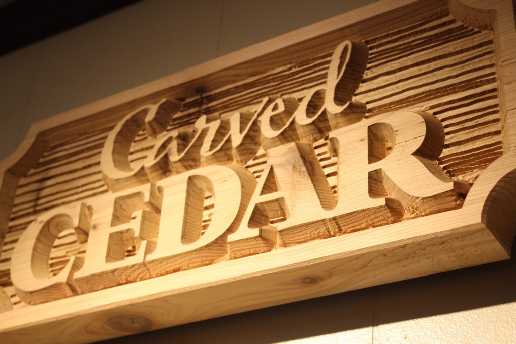 Carved Cedar - board with wood grain texture and raised letters