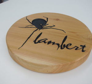 Lambert - clear coated cedar with routed down graphics painted black