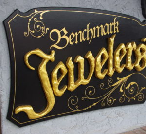 Benchmark Jewelers - MDO plywood painted black and gold, raised letters with hand texturing
