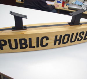 Publice House - convex carved Douglas Fir with carved down lettering