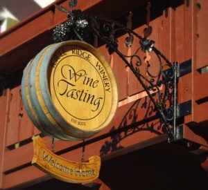 Icicle Ridge Winery - modified wine barrel with hand painted lettering, custom made steel bracket