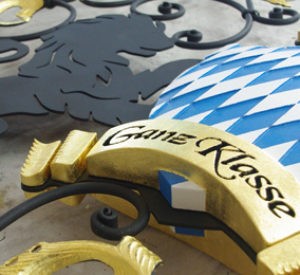 Ganz Klasse - steel painted matte black with gold leaf accents, HDU carved shield and ribbon