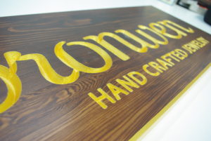 Bronwen - staind and clear coated cedar with v-carved letters painted metallic gold