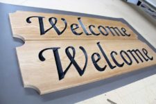 Carved wooden signs that say "Welcome"