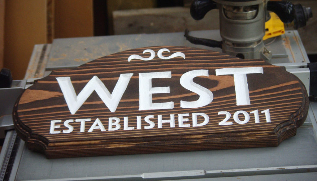 Wooden name sign with carved letters