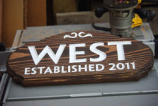 Wooden name sign with carved letters