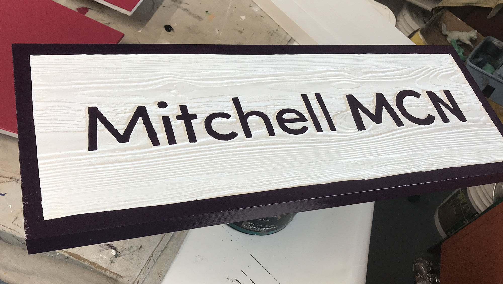 Sandblasted wood sign reading Mitchell MCN