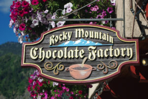 Rocky Mountain Chocolate Factory wooden sign hanging from metal bracket