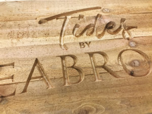Carved letters into wood.