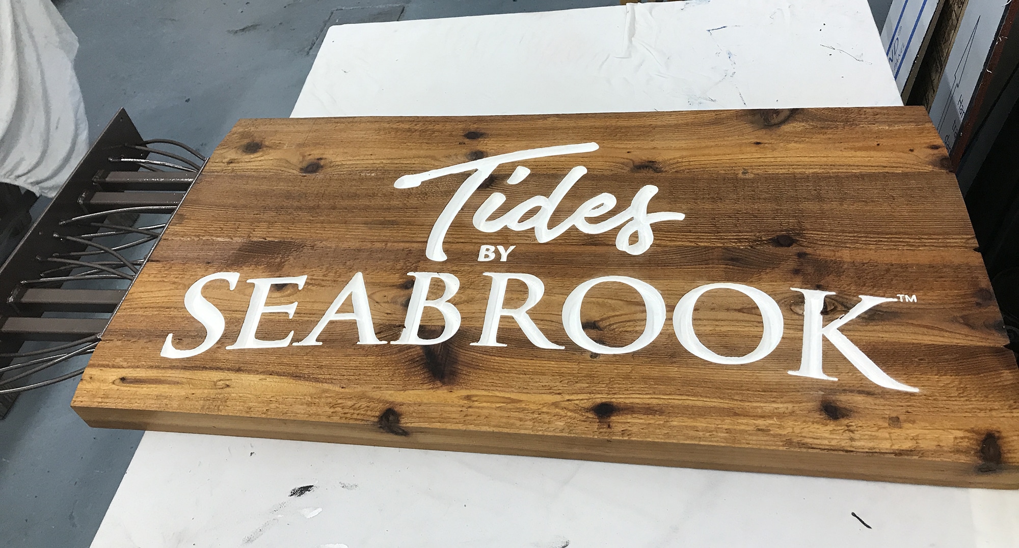 Wood sign with v-carved white letters.