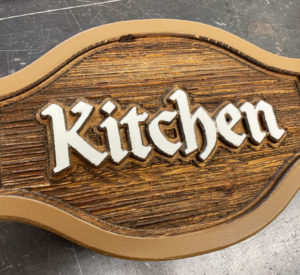 carved wooden kitchen sign