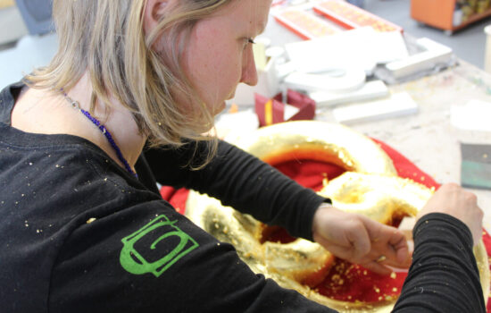 Amanda Gibbs applying gold leaf
