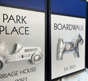 large monopoly game pieces on signs