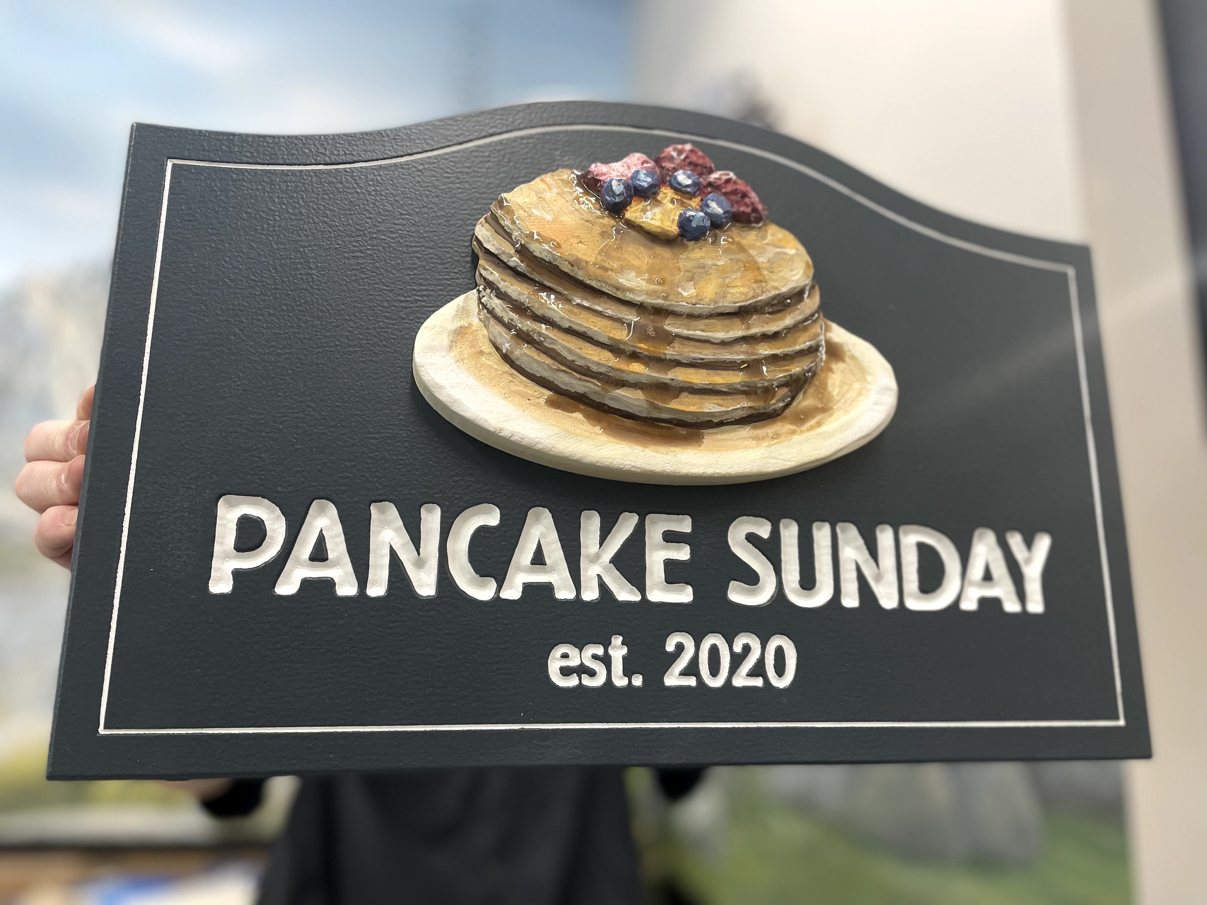 sign with a stack of carved pancakes