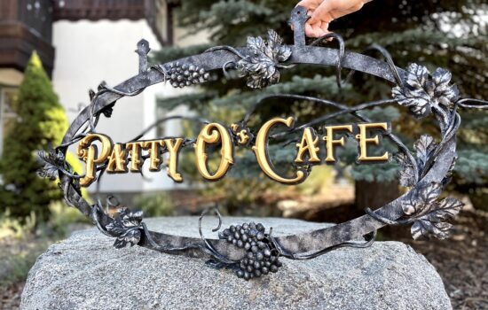 wrought iron sign with vines and leafs