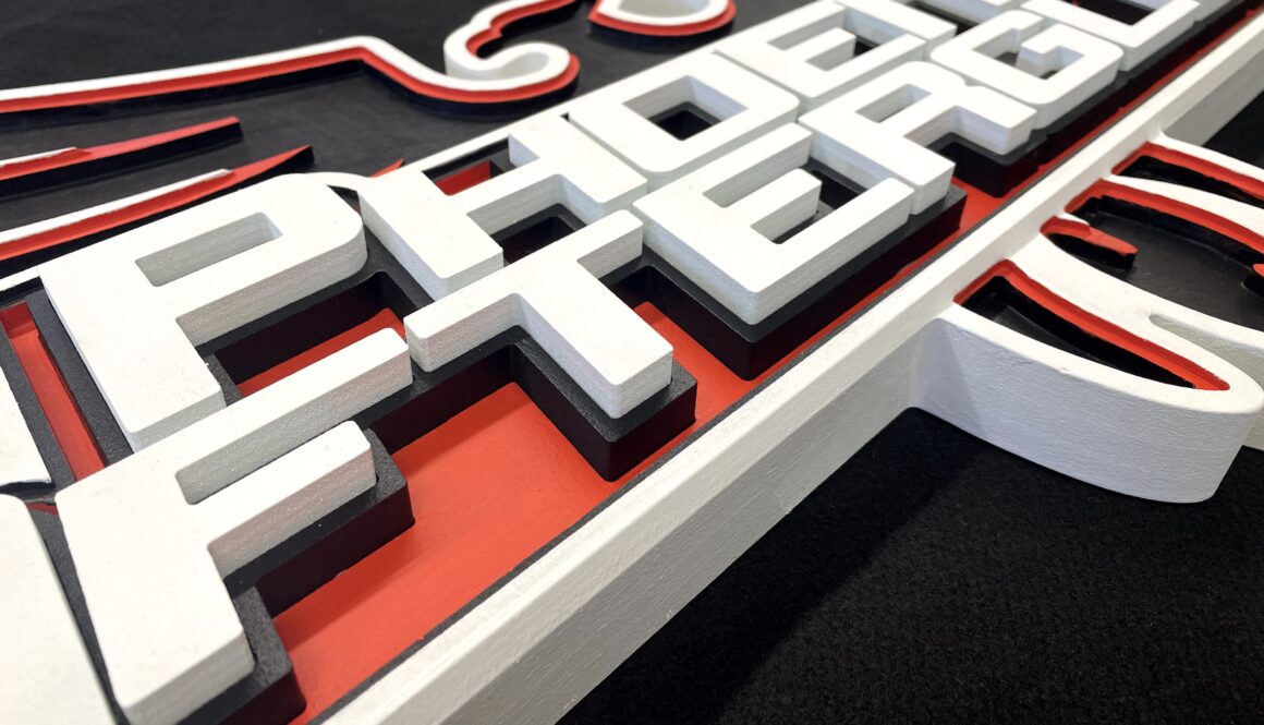 Black, white and red sign with 3D letters
