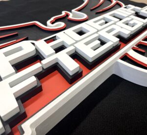 Black, white and red sign with 3D letters
