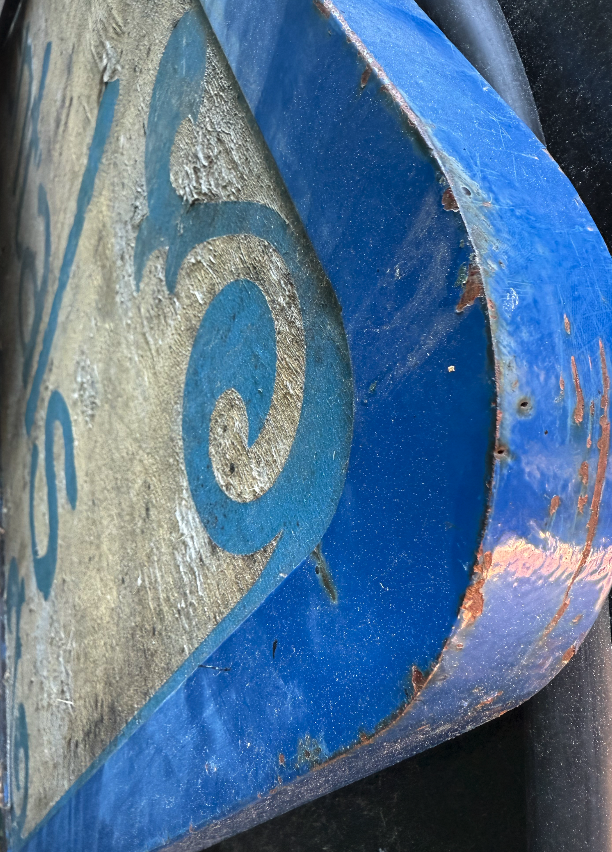 Sign with rusted metal frame around it