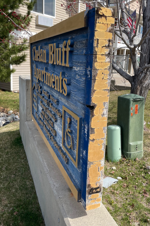 old wooden sign with peeling paint